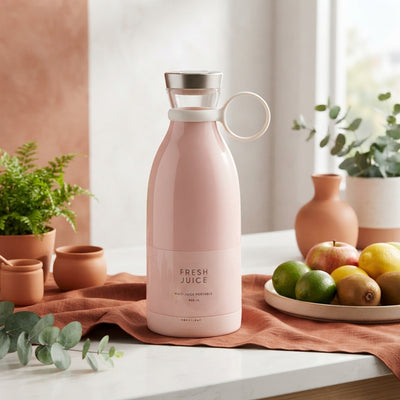 A portable mini juice blender displayed on a white surface with terracotta and burnt sienna accents.